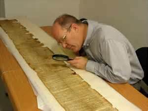Researcher analyzing one of the Dead Sea Scrolls